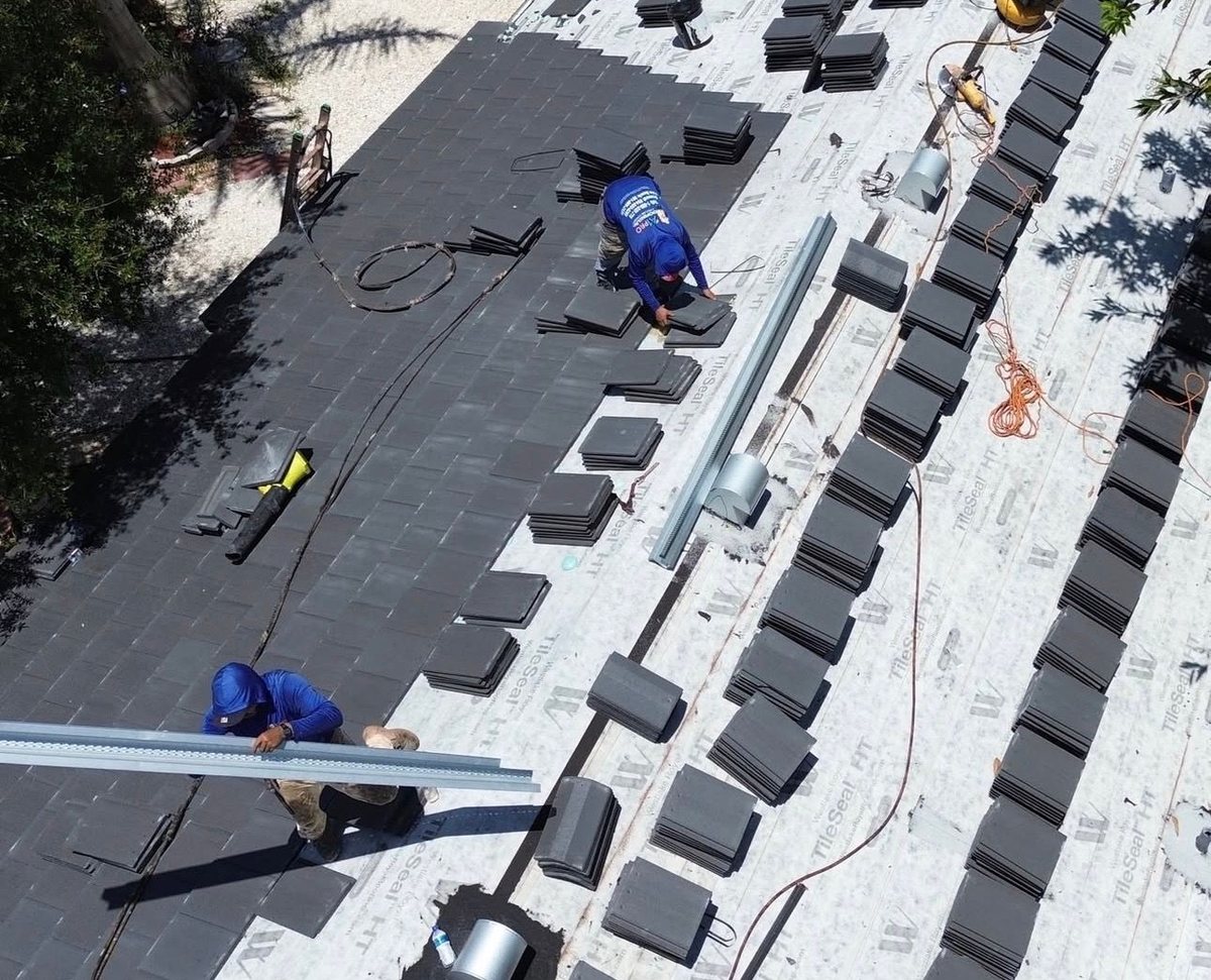 A1 Pro Roofing crew installing new dark concrete tile on a residential roof
