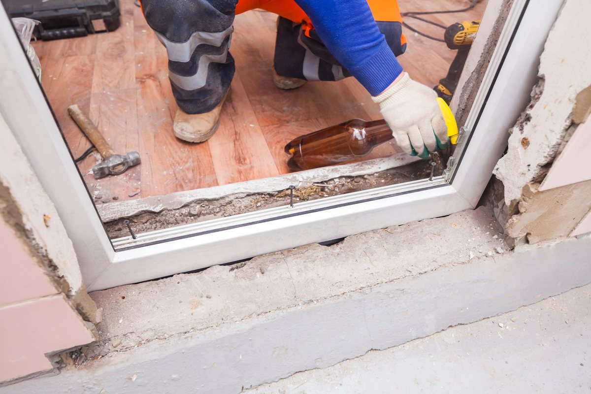 A worker installing an energy-efficient window frame